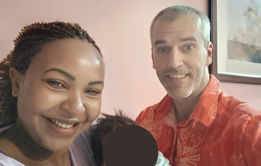 Carolina Carlz and hubby Troy holding their baby