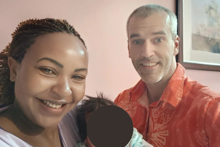 Carolina Carlz and hubby Troy holding their baby