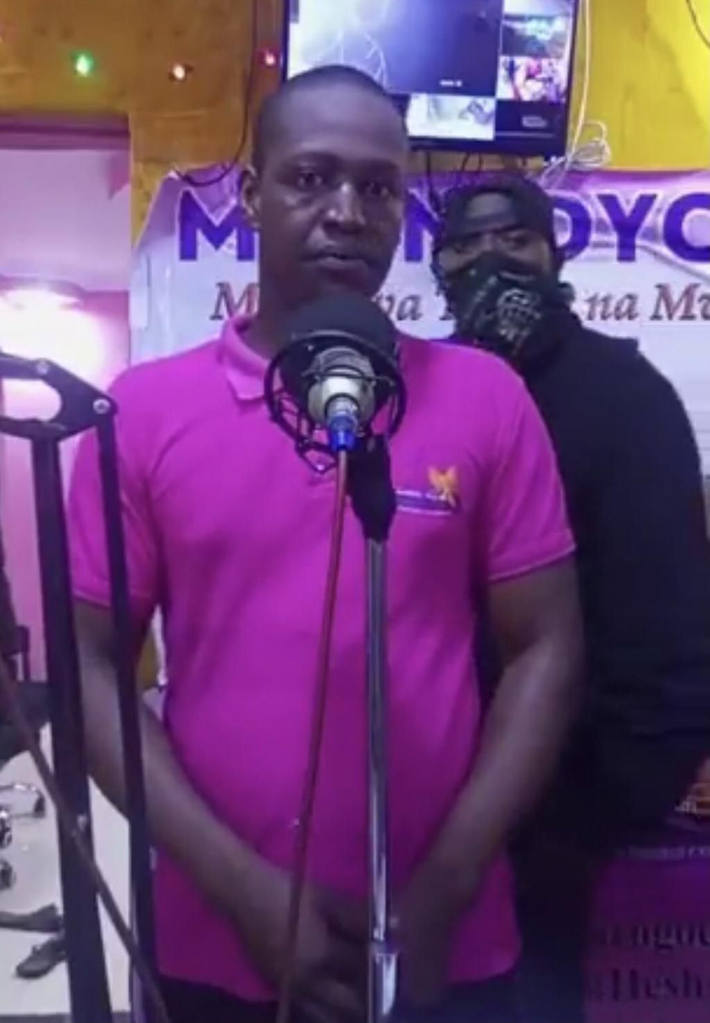 A Mwinjoyo FM presenter and a thug behind him