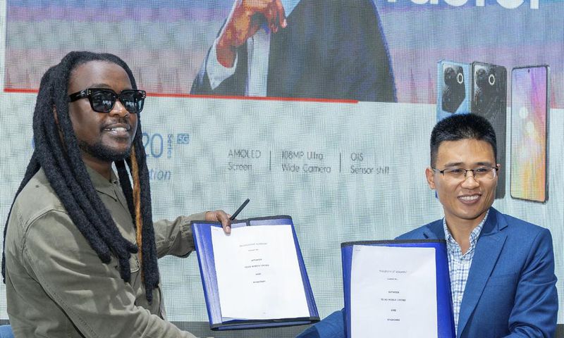 CAMON 20 series Brand Ambassador, Nyashinski and TECNO Kenya Brand Manager, Peter Shi show off a signed copy of the contract during the unveil event held at the Social House on May 9, 2023