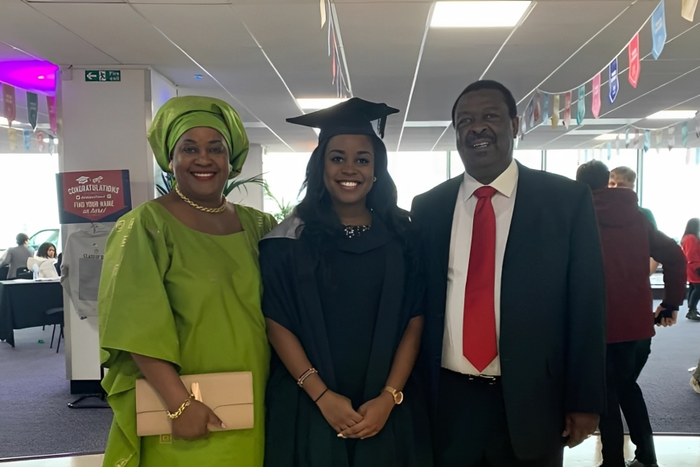 Maryanne Mudavadi with her parents during her graduation
