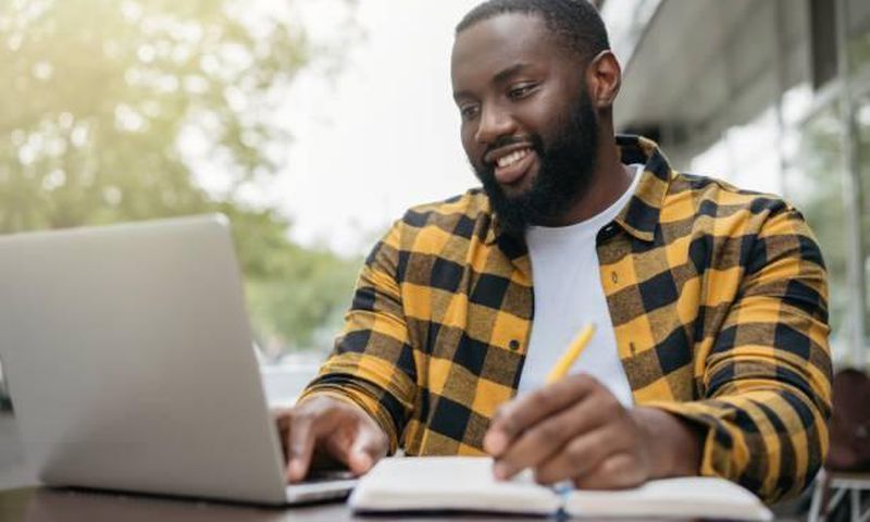 A man engaged in an online activity Photo Credits - Mirel Kipioro