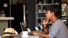 A Black woman with her laptop [Go Banking Rates]