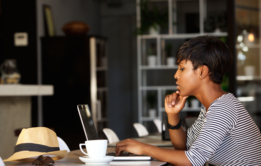 A Black woman with her laptop [Go Banking Rates]