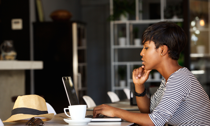 A Black woman with her laptop [Go Banking Rates]