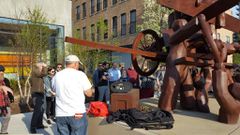 Labour activist and tour guide Larry Spivack speaks to Union of Democratic Communications conference-goers at the Haymarket Memorial in Chicago in 2018 [Image Credit: Weave News]