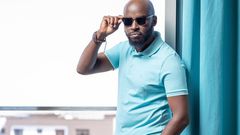 Journalist Mark Masai poses for a photo