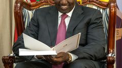 President William Ruto peruses through a document at State House