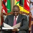 President William Ruto peruses through a document at State House