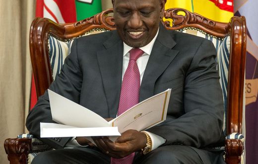 President William Ruto peruses through a document at State House