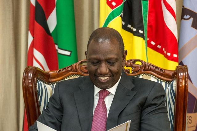 President William Ruto peruses through a document at State House