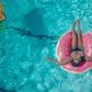 Woman on a pink swim ring [Photo: Kindel Media]