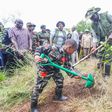President William Ruto planting a tree alongside a young boy during the National Tree Planting Day in Murang'a County on May 10, 2024