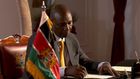 President William Ruto signs a document at State House