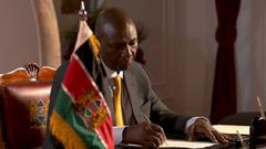 President William Ruto signs a document at State House