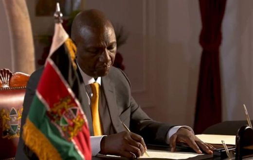 President William Ruto signs a document at State House