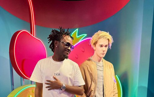 Singer Bahati posing next to the wax statue of pop singer Justin Bieber at Madame Tussauds Museum, Singapore
