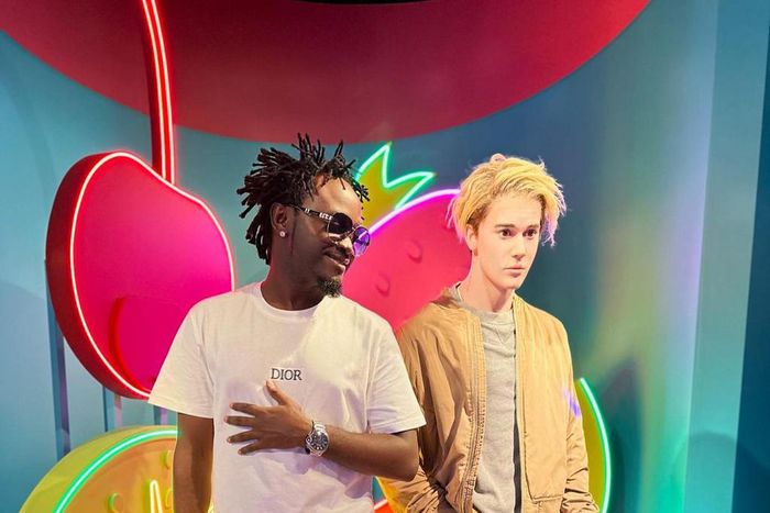 Singer Bahati posing next to the wax statue of pop singer Justin Bieber at Madame Tussauds Museum, Singapore
