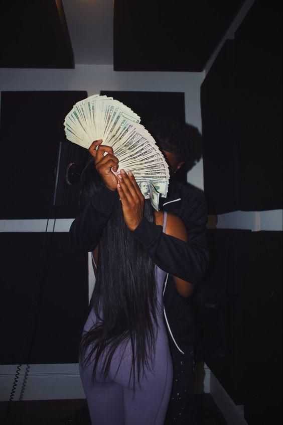 Couple being intimate while showing off money/Courtesy