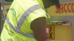A traffic officer inspecting a vehicle