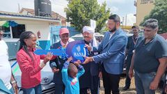 Rana Motors presents a dummy key as a car present to Faith Kipyegon's father in Eldoret