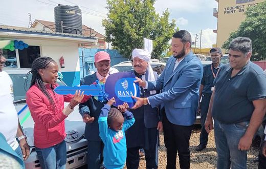 Rana Motors presents a dummy key as a car present to Faith Kipyegon's father in Eldoret