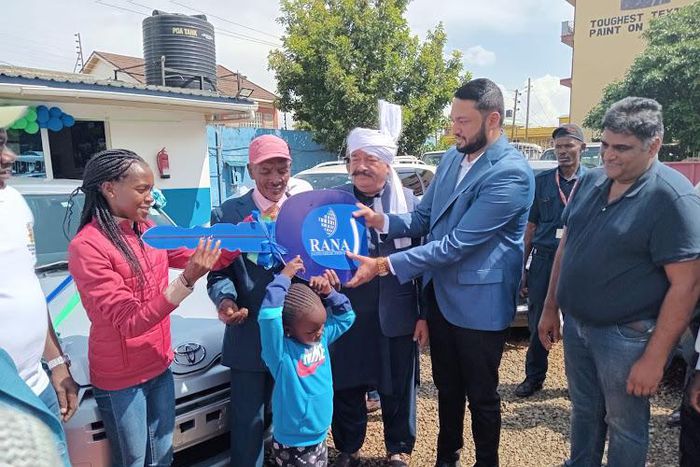 Rana Motors presents a dummy key as a car present to Faith Kipyegon's father in Eldoret