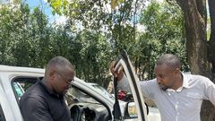 Seth Olale looks at the shattered windows of Citizen TV vehicle