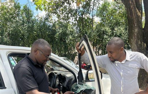 Seth Olale looks at the shattered windows of Citizen TV vehicle