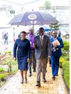 President William Ruto holds an umbrella to shield Health CS Susan Nakhumicha from rains in Syokimau, Machakos County on November 22, 2023.