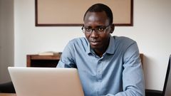 An AI generated image of a man working on a laptop