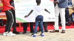 President William Ruto hands Faith Kipyegon a dummy cheque of Sh5 million at State House, Nairobi on June 13, 2023