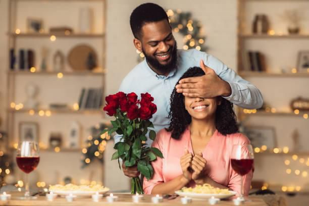 A romantic man giving her woman a flower
