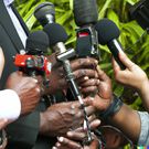 Journalists in a press briefing source - AI-Generated DALL·E