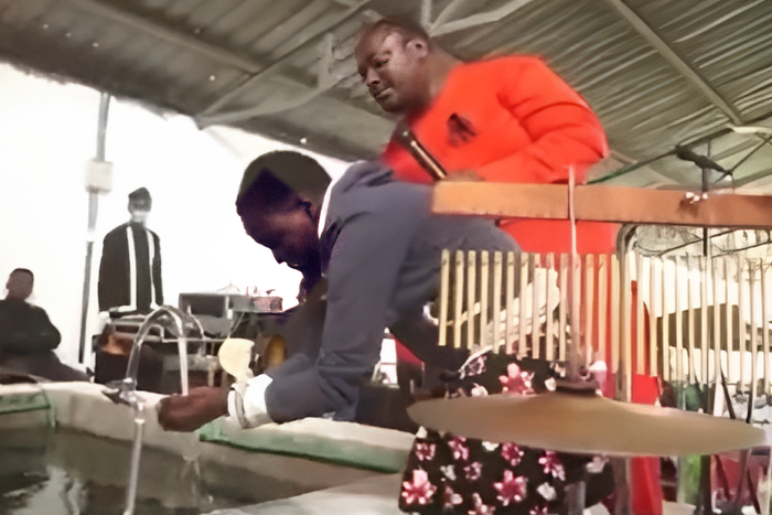 Pastor Kanyari directing one of his follower to wash her face and drink water from his newly built 'Bethsaida' pool