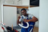 A man repairing a sink