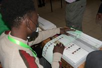 An IEBC clerk issues ballot papers to a voter during the 2022 General Election on August 9, 2022