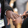 An election official marks the nail of a voter to indicate they have cast their ballots and completed voting at a polling station in the Mathare neighborhood of Nairobi. Photo Credit: Nickolai Hammar/NPR