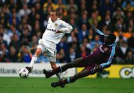 Lee Bowyer (Leeds) skips past the late Marc Vivien Foe (West Ham) on October 30, 1999.