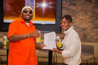 Ndovu Kuu after signing up as new Tusker brand Ambassador with him is Tusker brand manager Catherine Twesigye
