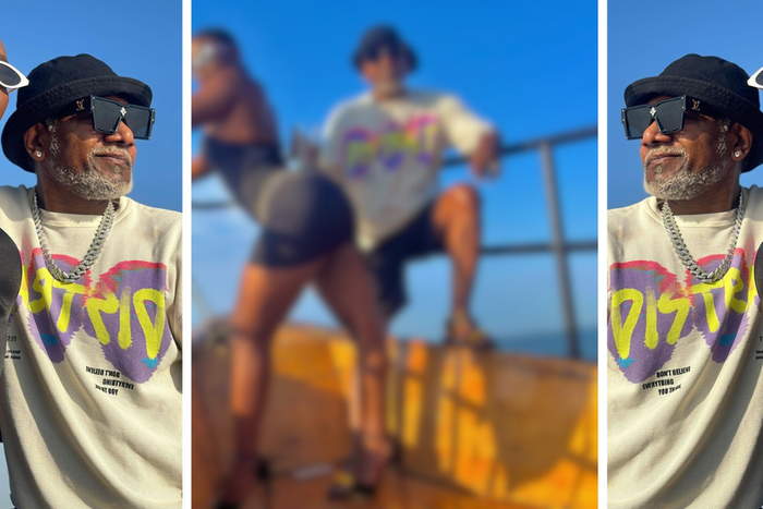 Awilo Longomba retires drink on Ritah Dancehall's backside on sailing excursion/Instagram