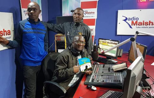 Hassan Ali Kauleni (seated) posing with Nuru Ya Lugha panelists.