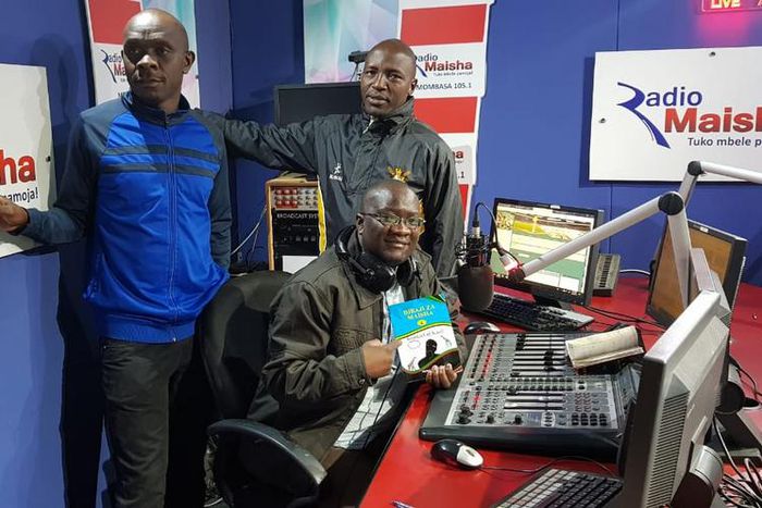 Hassan Ali Kauleni (seated) posing with Nuru Ya Lugha panelists.