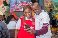 Sports Media Personality Carol Radul poses for a selfie with a fan during theGuinness brightest matchday made by the fans at Bar Next Door, Kiambu Road.