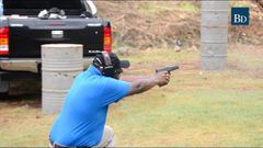 A person practising shooting at a gun range
