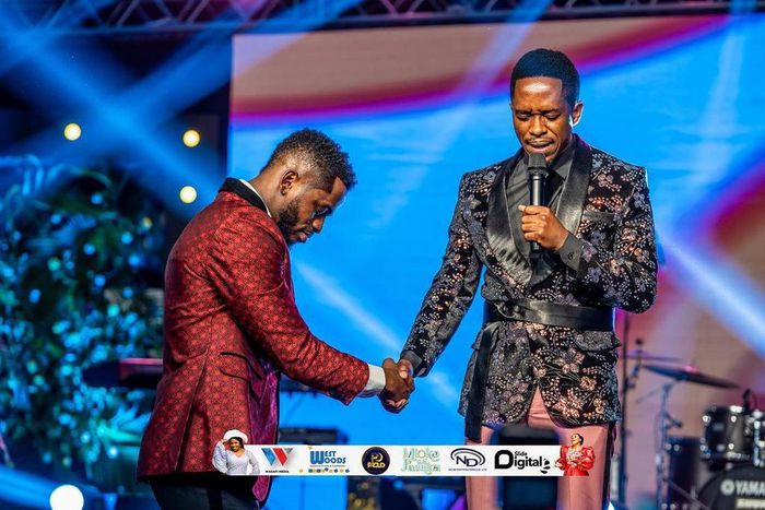 Diamond Platnumz being prayed for by a preacher