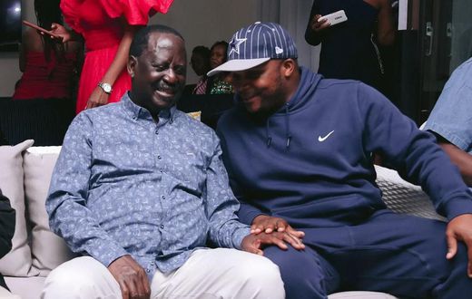 ODM leader Raila Odinga speaks with Lang'ata MP Jalang'o during a birthday party at Saboti MP Caleb Amisi's house