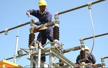 A Kenya Power employee working on a power line