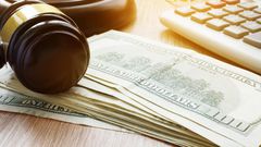 A stock image shows a gavel, keyboard, and dollar notes.designer491/Getty Images
