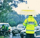 A traffic officer in Nairobi on a rainy day